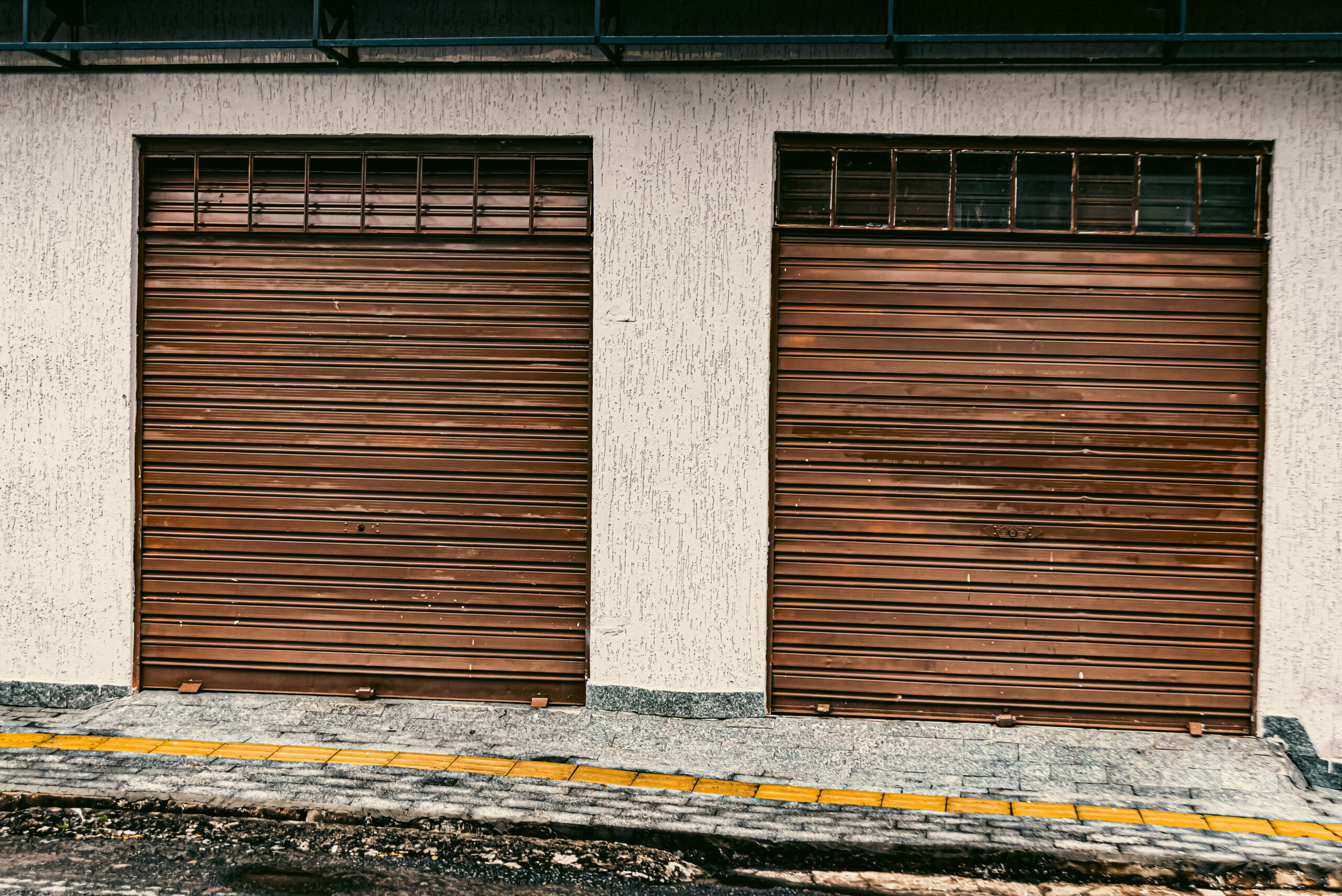 Worn Commercial Garage Doors on an industrial building showing signs of aging and damage